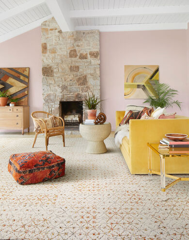 Home office with orange and peach flowers featuring FLOR Vintage Vibe area rug shown in Coral