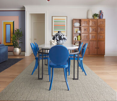 Dining room FLOR Tweed Indeed area rug shown in Pearl