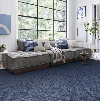 Sitting area with FLOR Open Invitation area rug shown in Cobalt.